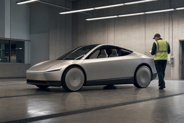 Tesla Cybercab without steering wheel undergoing federal safety inspection in concrete bay