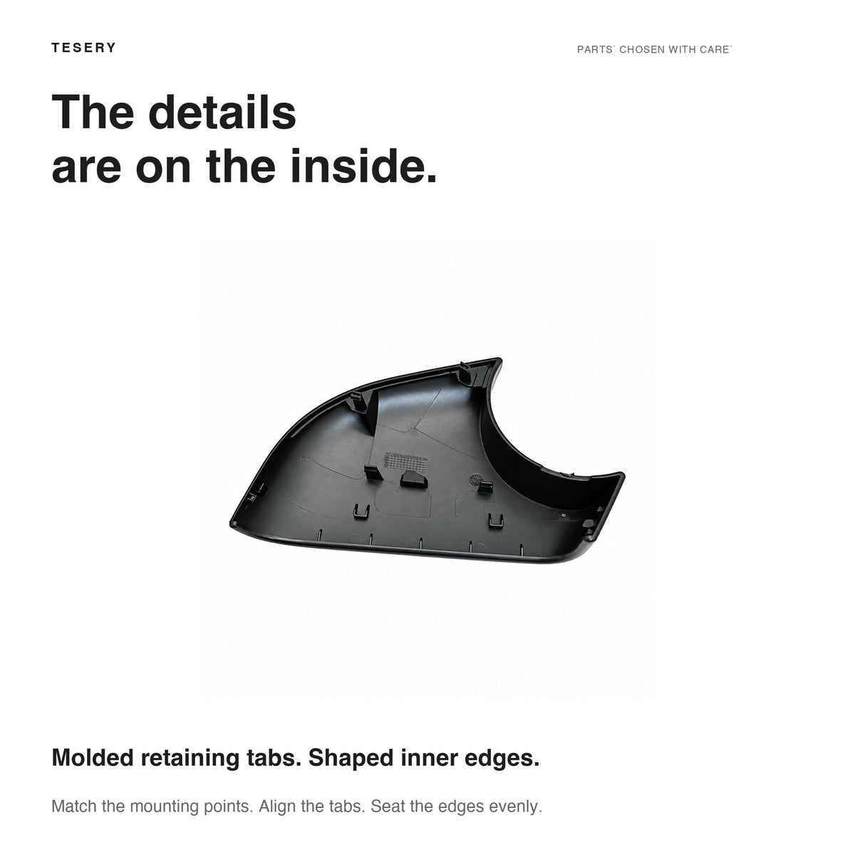 Interior of the Model Y left lower mirror cover showing molded retaining tabs, ribs and shaped inner edges