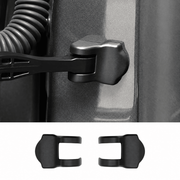 Black door check-arm mounting cover installed on a door jamb above a pair of separate covers.