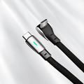 Two USB-C plugs with braided black cable jackets, including a right-angle connector and a green indicator.