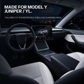 Wide refreshed Tesla cabin view with a cyan light frame around the charging area