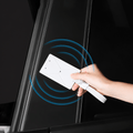 Hand holding a white key-card sleeve near a door pillar, with blue signal-wave graphics.