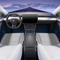 Wide cabin illustration showing white cushion pads on both front seats beneath a snowy road view.