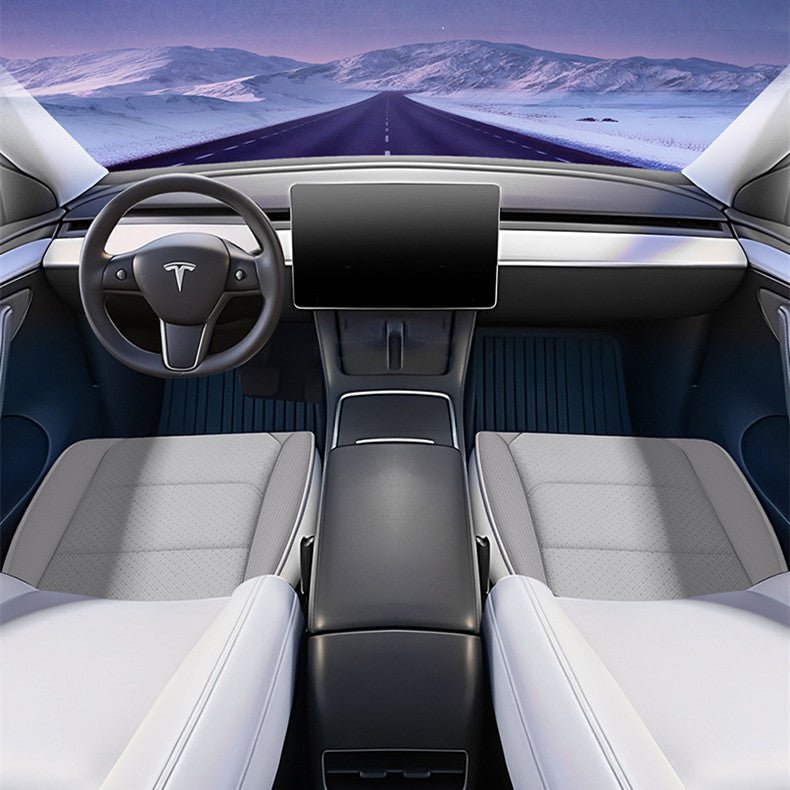 Wide cabin illustration showing white cushion pads on both front seats beneath a snowy road view.